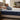 Man resting on a mattress in a bright bedroom